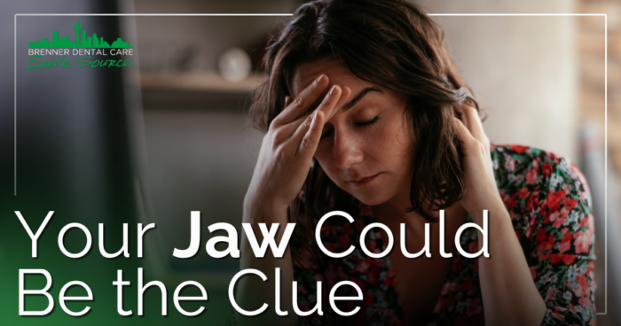 woman in pain holding head and neck