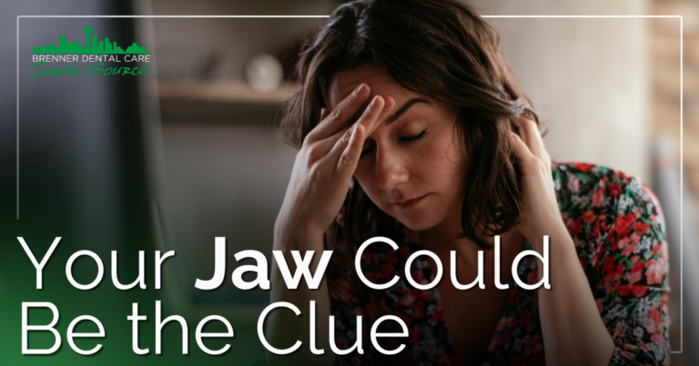 woman in pain holding head and neck